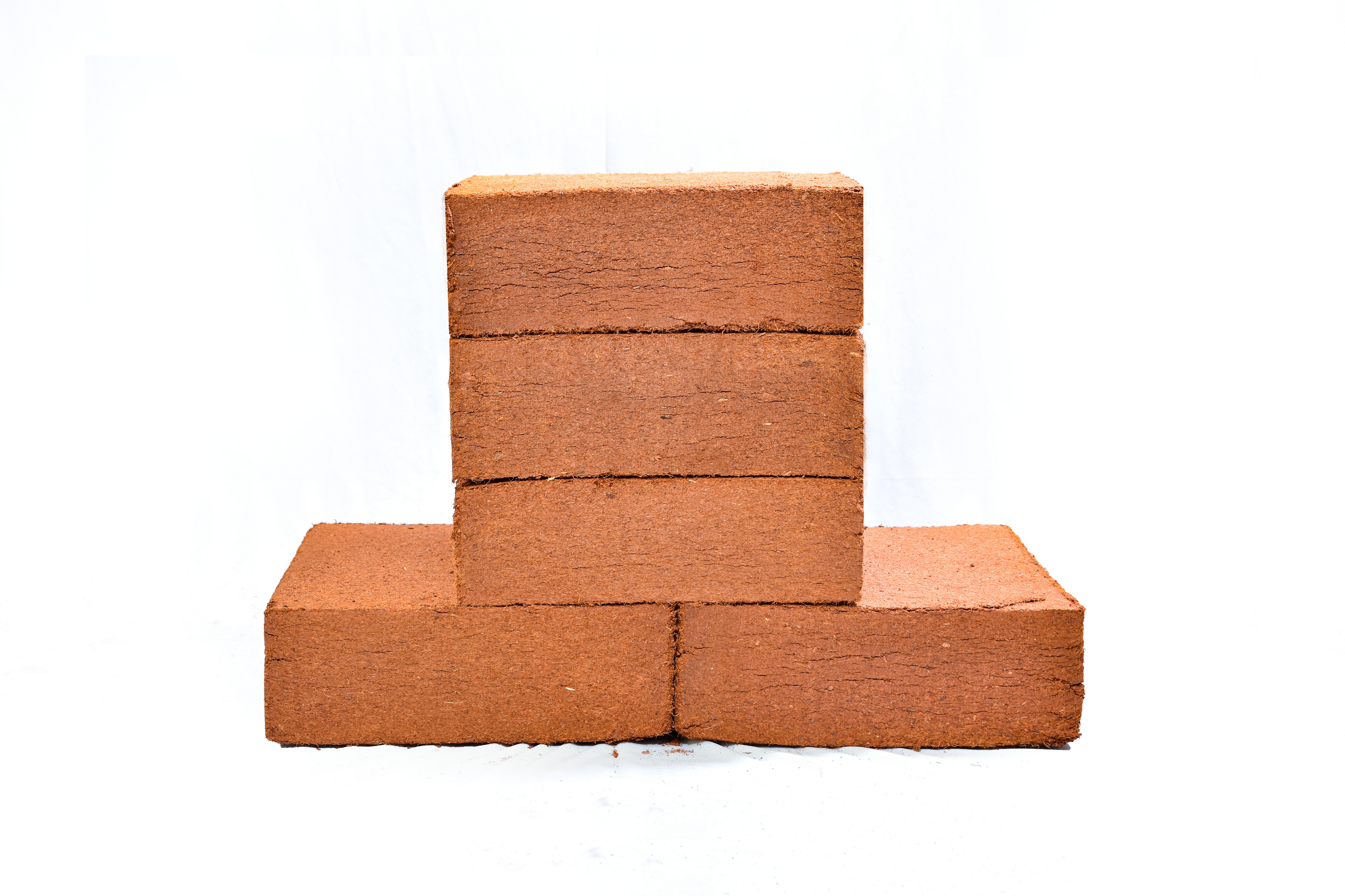 Bare coco peat blocks stacked for direct floor loading